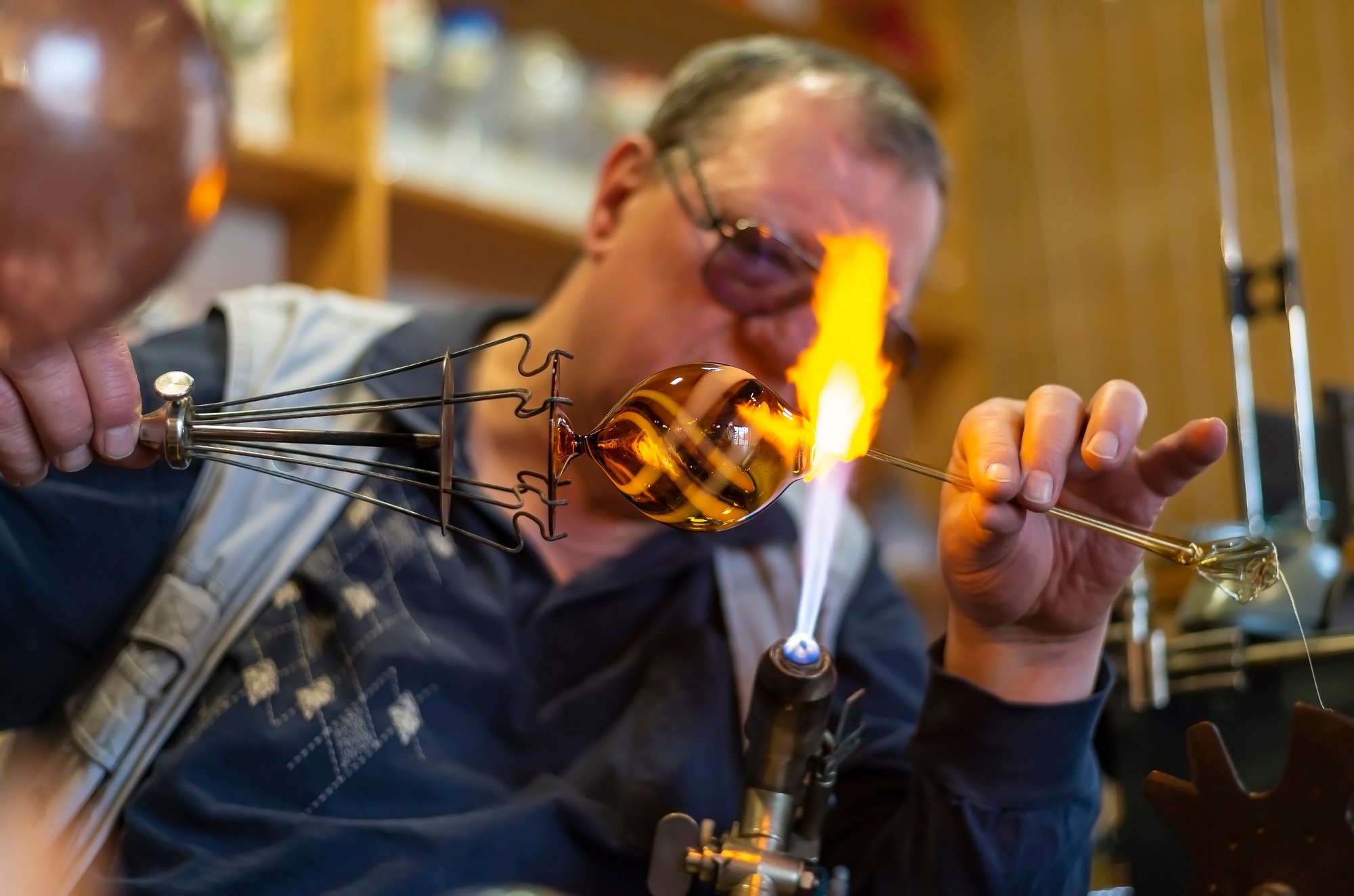 Glass blower forming melting glass